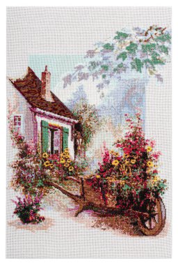 Embroidered picture, flowers in the yard of a rural house, cross-stitch on textile canvas, isolated on white background