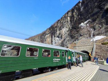 Myrdal, Norway: 3 May 2022 - Flam railway train at Kjosfossen station clipart