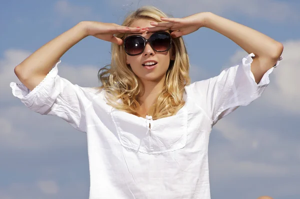 Beautiful girl in sunglasses on background blue sky Stock Picture