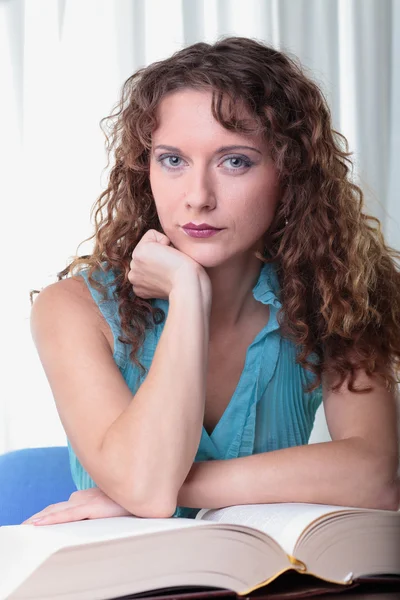 Young woman with book on white background. — Stock Photo, Image