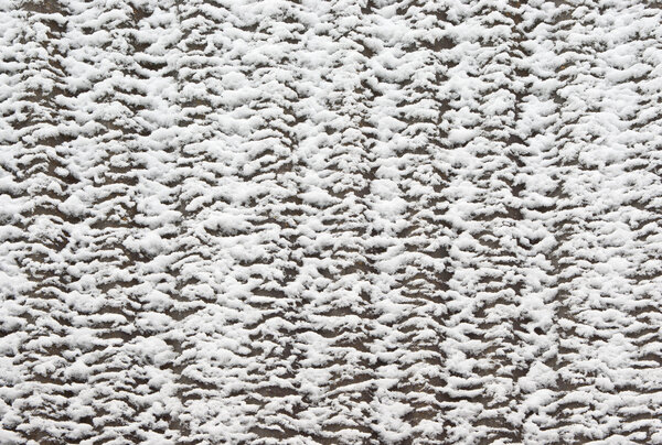 Slate roof covered with thawing snow