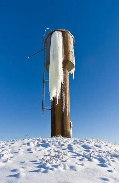 Big icicle on a water tower — Stock Photo, Image