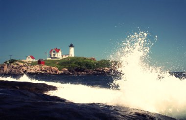 Waves crashing in front of Nubble Lighthouse clipart