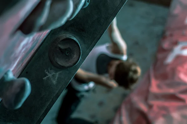 Climbing wall with climber in background