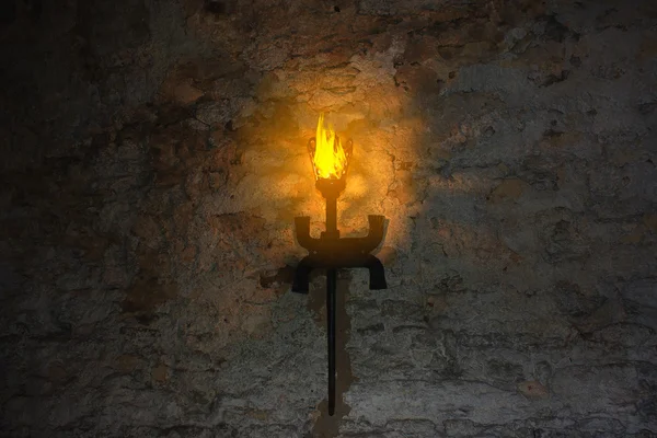 Факел на стене старого замка — стоковое фото