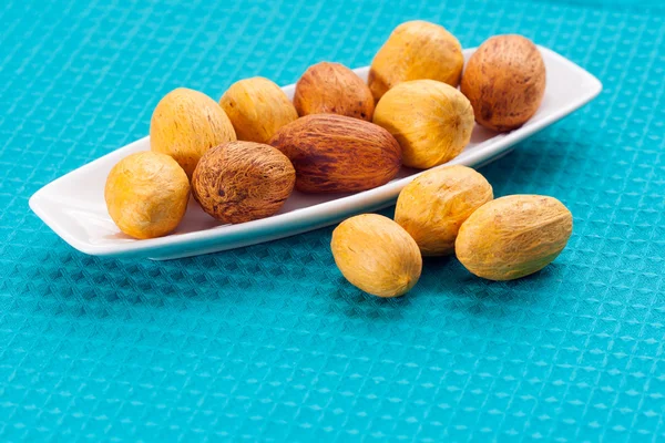 Large nuts on a plate — Stock fotografie