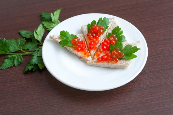 Tartlets with caviar and parsley on a plate — Stock Photo, Image