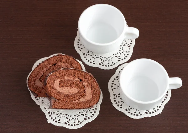 Chocolate roll on napkins and cup — Stock Photo, Image