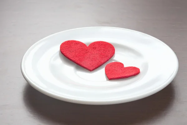 Red hearts on a plate — Stock Photo, Image