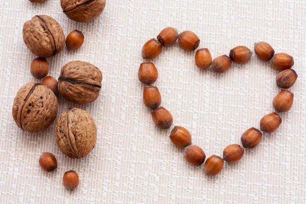 Walnuts, hazelnuts on a wooden background — Stock Photo, Image