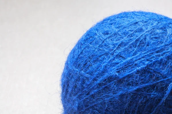 Blue wool yarn skein on cardboard background — Stock Photo, Image