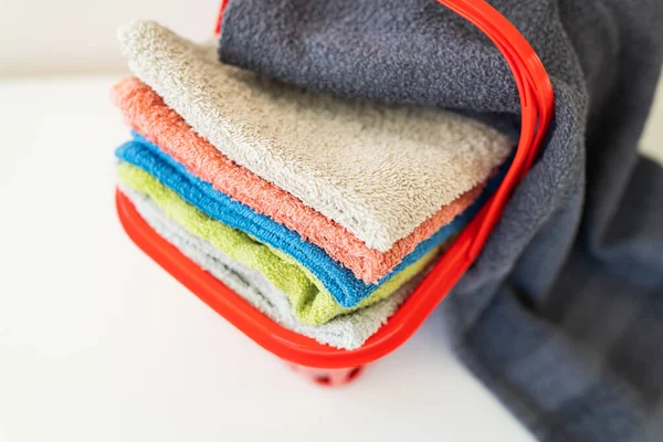 Multi Colored Towels Lie Red Laundry Basket White Background Washing — Stock Photo, Image
