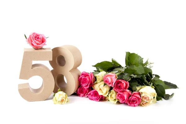 Âge en chiffres sur un lit de roses — Photo