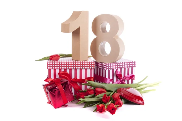 Age in figures in a party mood on a bed of red tulips — Stock Photo, Image