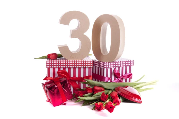 Age in figures in a party mood on a bed of red tulips — Stock Photo, Image