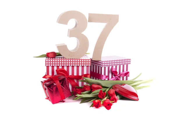 Age in figures in a party mood on a bed of red tulips — Stock Photo, Image