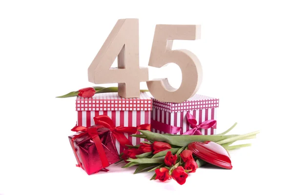 Age in figures in a party mood on a bed of red tulips — Stock Photo, Image