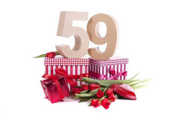 Age in figures in a party mood on a bed of red tulips — Stock Photo, Image