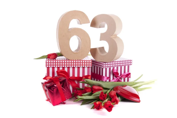 Age in figures in a party mood on a bed of red tulips — Stock Photo, Image