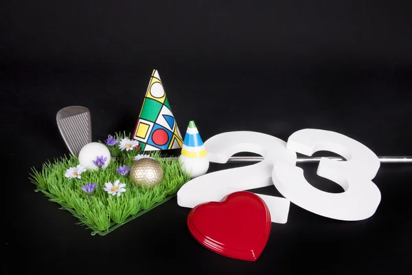 A golf club and golf ball on an artificial peace of grass to be used as a birthday card — Stock Photo, Image