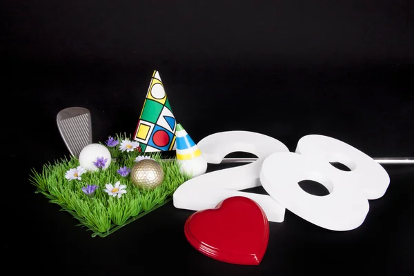 A golf club and golf ball on an artificial peace of grass to be used as a birthday card — Stock Photo, Image