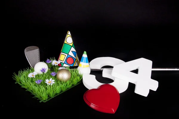 En golfkølle og en golfball på en kunstig gressfred som skal brukes som bursdagskort – stockfoto