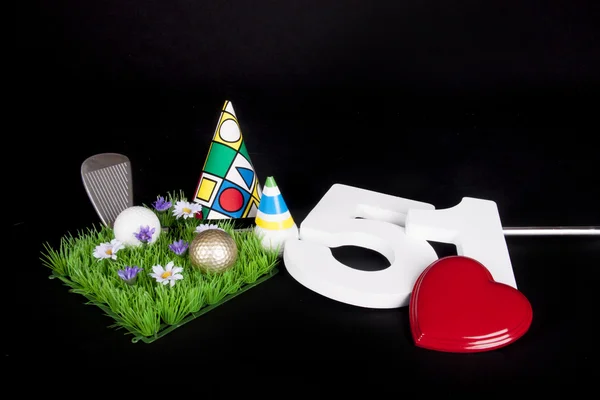 A golf club and golf ball on an artificial peace of grass to be used as a birthday card — Stock Photo, Image