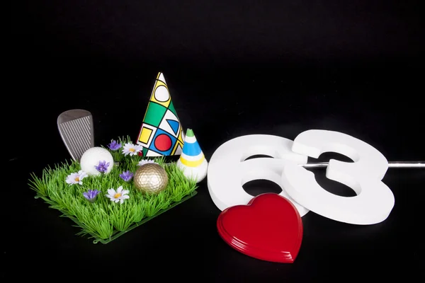 A golf club and golf ball on an artificial peace of grass to be used as a birthday card — Stock Photo, Image