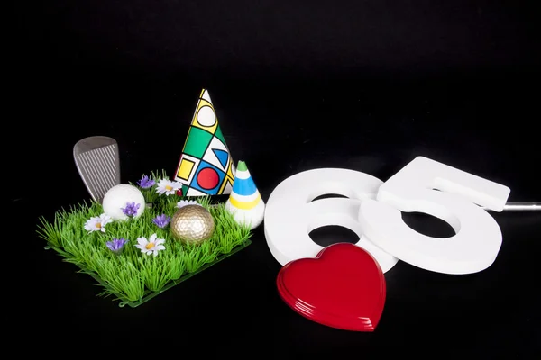 A golf club and golf ball on an artificial peace of grass to be used as a birthday card — Stock Photo, Image