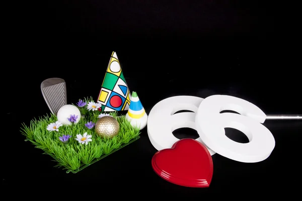 A golf club and golf ball on an artificial peace of grass to be used as a birthday card — Stock Photo, Image