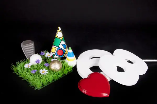 A golf club and golf ball on an artificial peace of grass to be used as a birthday card — Stock Photo, Image