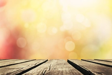 Wooden table with autumn leaves background, Multicolored leafs in sunny fall afternoon 