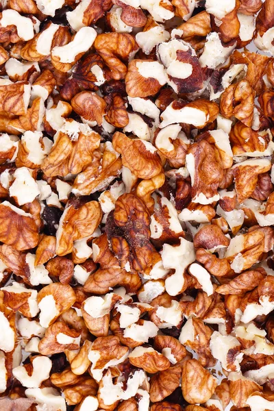 Pozadí drcených vlašských ořechů — Stock fotografie