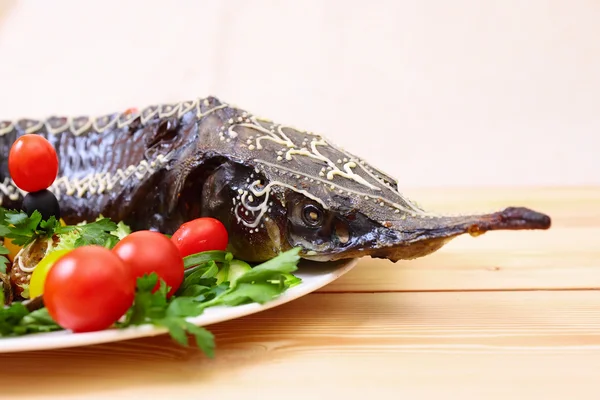 Sturgeon baked with vegetables and greens — Stock Photo, Image