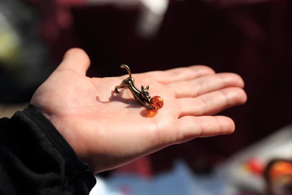 Jewelry miniature of playing kitty on the hand — Stock Photo, Image