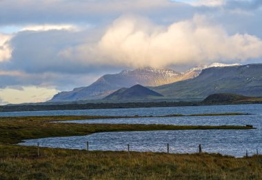 View during auto trip in West Iceland highlands, Snaefellsnes peninsula, Snaefellsjokull National Park. Spectacular volcanic tundra landscape with mountains, craters, lakes, gravel roads.
