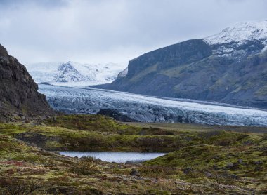 Iceland autumn tundra landscape near Haoldukvisl glacier, Iceland. Glacier tongue slides from the Vatnajokull icecap or Vatna Glacier near subglacial Esjufjoll volcano. Not far from Iceland Ring Road.