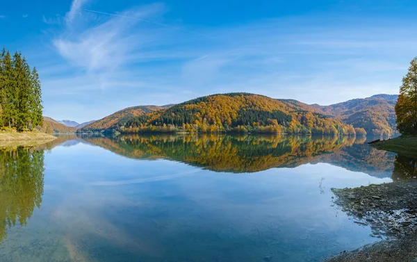 Vilshany water reservoir on the Tereblya river, Transcarpathia, Ukraine. Picturesque lake with clouds reflection. Beautiful autumn day in Carpathian Mountains.