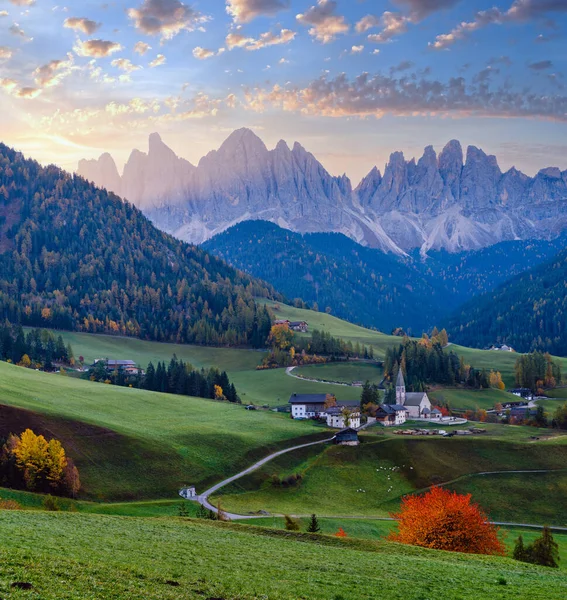 Autumn daybreak Santa Magdalena famous Italy Dolomites village view in front of the Geisler or Odle Dolomites Group mountain rocks. Picturesque traveling and countryside beauty concept background.