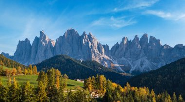 Autumn evening Santa Magdalena famous Italy Dolomites village surroundings in front of the Geisler or Odle Dolomites mountain rocks. Picturesque traveling and countryside beauty concept background. clipart