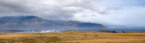 View during auto trip in Iceland. Spectacular Icelandic landscape with  scenic nature: mountains, ocean coast, fjords, fields, clouds, glaciers, waterfalls..