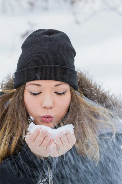 Beautiful woman blowing snow — Stock Photo, Image