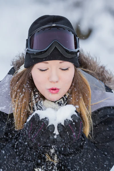 Beautiful woman blowing snow — Stock Photo, Image