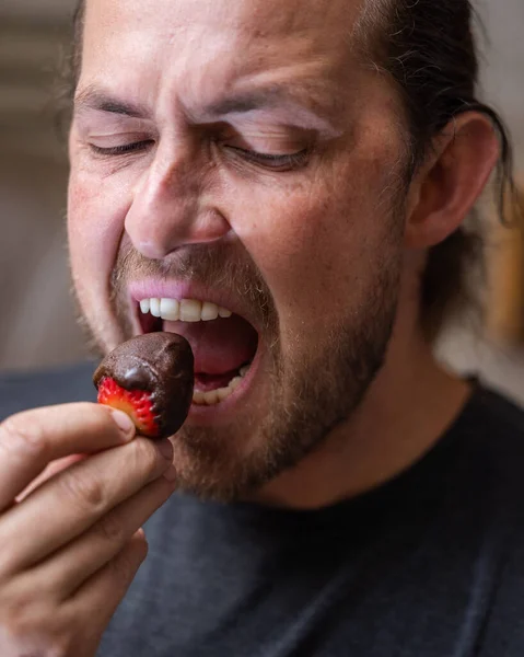 Man Eating Chocolate Covered Strawberry Close Portrait — Stockfoto
