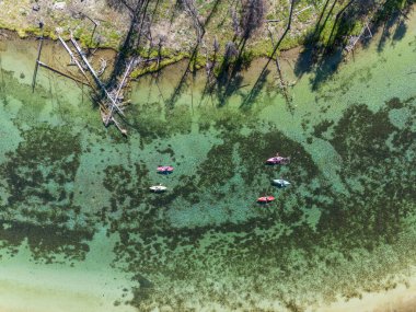 Group of people kayaking Spring Creek, a cristal clear river in Southern Oregon
