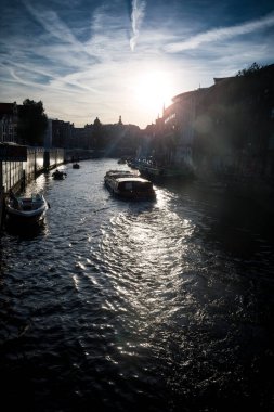 Dramatic sunlight over canal in Amsterdam Netherlands