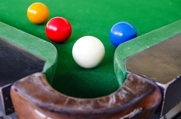 Snooker balls on green surface near pocket — Stock Photo, Image