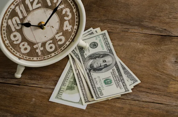 Primer plano, Tiempo y dinero en la mesa de madera — Foto de Stock