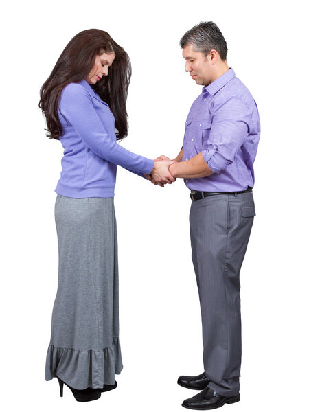 Husband and wife hold hands and pray