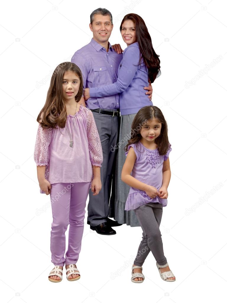 Two young smiling sisters stand in front of parents
